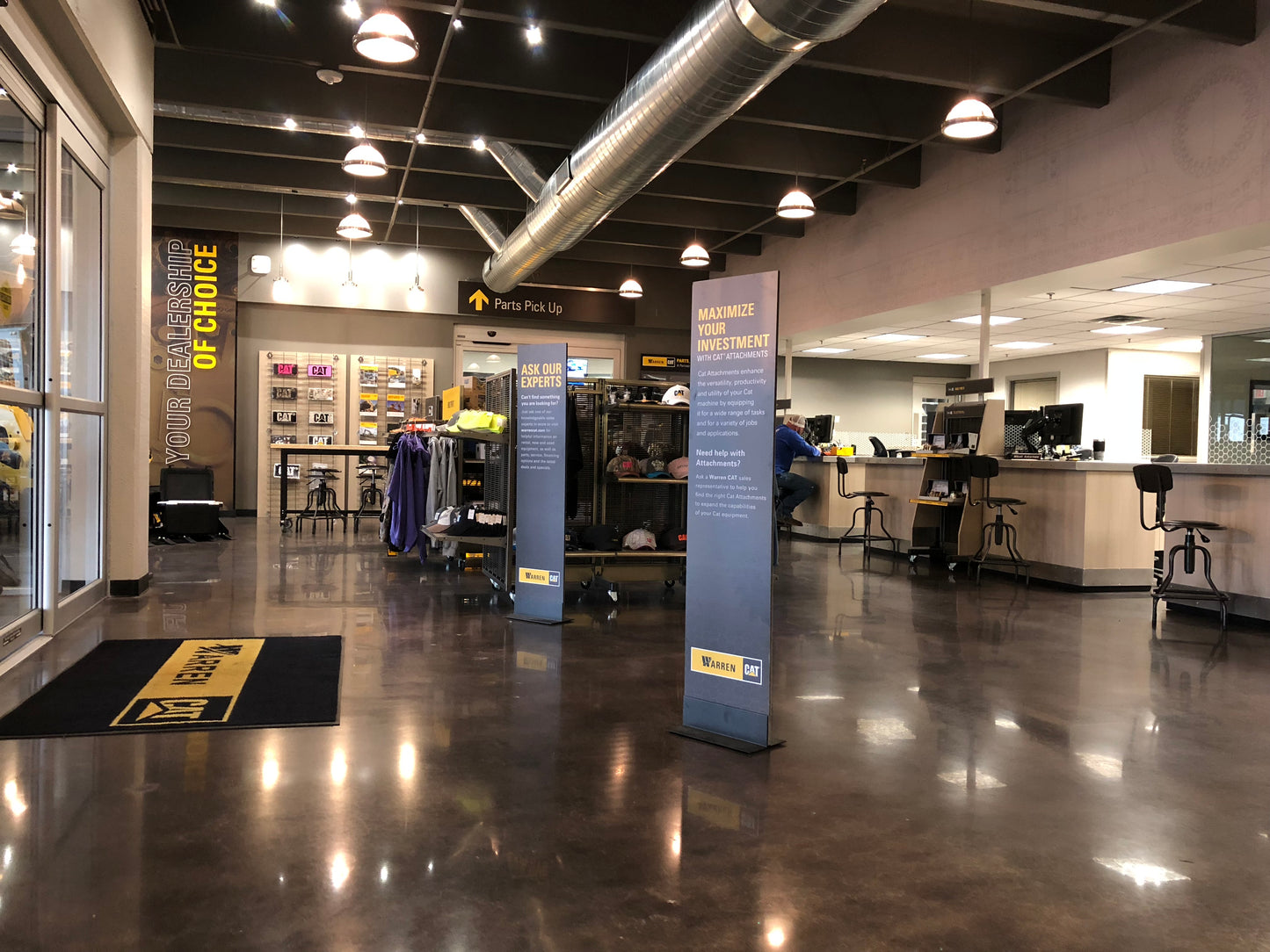 Interior of a store with promotional signs and a polished floor.